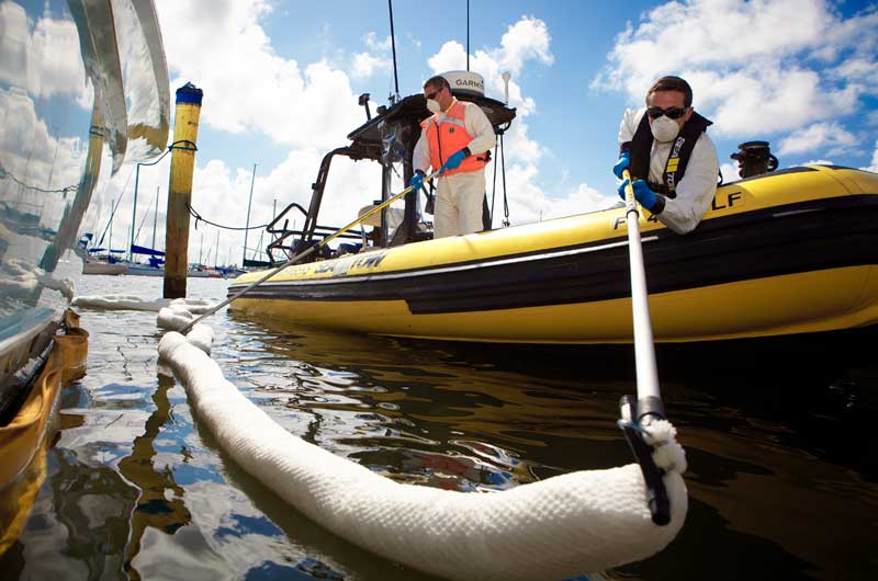 Captain containing an oil spill. Sea Tow has marine spill responder capabilities.