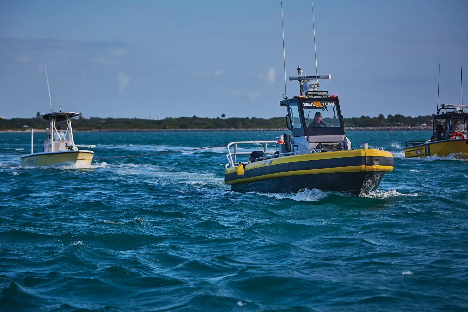 Sea Tow towing a boater to safety