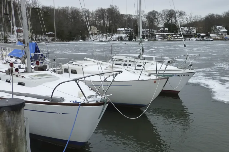 sailboats covered in ice in the winter