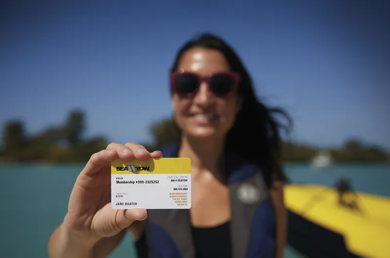 sea tow member holding membership card