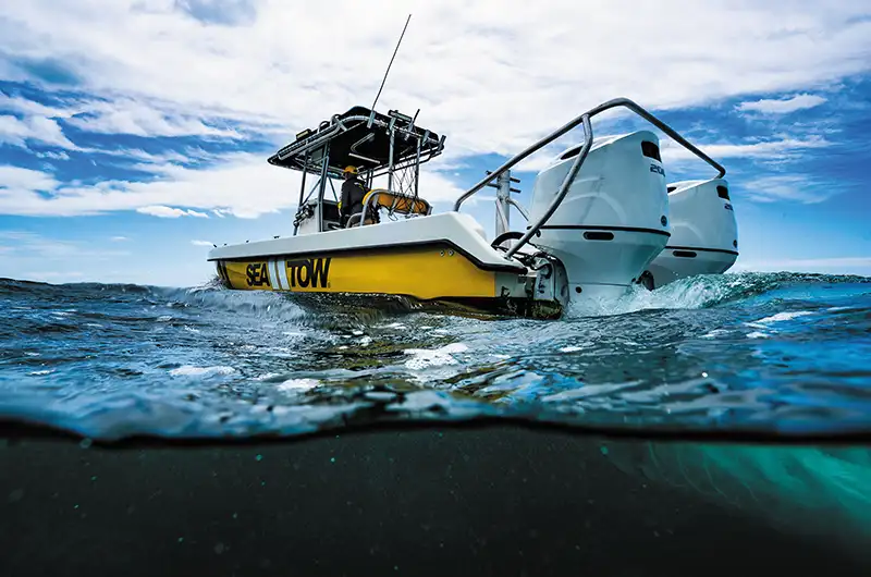 sea tow captain driving yellow boat